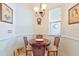 Bright breakfast nook with a chandelier, a window with blinds, and a round table at 1128 Travertine Ter, Sanford, FL 32771