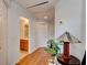 Hallway featuring hardwood floors, doors, and an opening looking into a bathroom with tiled floor at 1128 Travertine Ter, Sanford, FL 32771