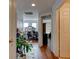 Hallway with wood floors, doors, and an opening looking into a room with a desk and chairs at 1128 Travertine Ter, Sanford, FL 32771
