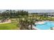 Resort-style community pool area with comfortable lounge chairs, umbrellas, and lush landscaping at 12821 Harvest Rain Ave, Winter Garden, FL 34787