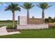 Elegant community sign for Harvest at Ovation, set amidst lush landscaping and palm trees at 12821 Harvest Rain Ave, Winter Garden, FL 34787