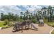 Community playground featuring wooden structures, slides, and climbing features for ' enjoyment at 12821 Harvest Rain Ave, Winter Garden, FL 34787