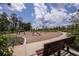 Community playground with climbing ropes, swings, and a bench overlooking it all at 12821 Harvest Rain Ave, Winter Garden, FL 34787