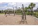 Community playground with climbing ropes, swings, and park benches at 12821 Harvest Rain Ave, Winter Garden, FL 34787