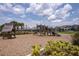 Community playground featuring various play structures and seating areas, surrounded by lush greenery at 12821 Harvest Rain Ave, Winter Garden, FL 34787