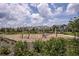 Community playground with slides, climbing ropes, and benches with lush green landscaping at 12821 Harvest Rain Ave, Winter Garden, FL 34787