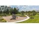 Community playground with winding walking paths, lush landscaping, and mature trees at 12821 Harvest Rain Ave, Winter Garden, FL 34787