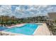 Resort-style community pool with comfortable lounge chairs for relaxing under the sun at 12821 Harvest Rain Ave, Winter Garden, FL 34787