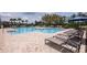 Resort-style community pool with sundeck, lounge chairs, and umbrellas for a relaxing experience at 12821 Harvest Rain Ave, Winter Garden, FL 34787