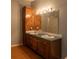 View of the bathroom featuring double sinks and a large mirror at 13010 Plum Lake Cir, Minneola, FL 34715