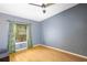 Bedroom featuring hardwood flooring and a window with decorative curtains at 13010 Plum Lake Cir, Minneola, FL 34715