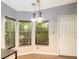 Cozy dining area with natural light, wood blinds and a stylish pendant light fixture at 13010 Plum Lake Cir, Minneola, FL 34715