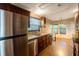 Bright kitchen with stainless steel appliances, granite countertops, and a view to the dining area at 13010 Plum Lake Cir, Minneola, FL 34715