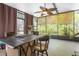 View of the sunroom with a ceiling fan and large windows at 13010 Plum Lake Cir, Minneola, FL 34715