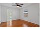 Bedroom with hardwood floors, ceiling fan, and door to back yard at 1309 W Yale St, Orlando, FL 32804