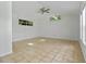 Bright, airy bedroom features tile flooring, natural light from several windows, and ceiling fan at 1309 W Yale St, Orlando, FL 32804
