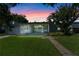 Charming single-story home with well-manicured lawn and inviting front porch at twilight at 1309 W Yale St, Orlando, FL 32804
