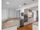 Modern kitchen with stainless steel appliances, white cabinetry, and breakfast bar at 1309 W Yale St, Orlando, FL 32804