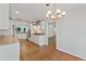 Bright, modern kitchen with stainless appliances, wooden floors, and stylish light fixture at 1309 W Yale St, Orlando, FL 32804