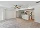 Expansive living room with neutral carpet, ceiling fan, and view into adjacent kitchen area at 1309 W Yale St, Orlando, FL 32804