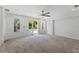 Spacious room with sliding glass doors opening to the pool area, carpeted floor, and ceiling fan at 1309 W Yale St, Orlando, FL 32804