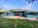 Backyard with brick patio, blue exterior, and green lawn at 13108 Long Pine Trl, Clermont, FL 34711