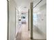 Hallway view leads to a bathroom with a shower, tub and vanity with mirrors in the distance at 13108 Long Pine Trl, Clermont, FL 34711