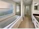 Bright bathroom with a soaking tub and a glass-enclosed shower at 13108 Long Pine Trl, Clermont, FL 34711