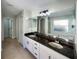 Elegant bathroom with dual sinks, granite counters, and a large mirror at 13108 Long Pine Trl, Clermont, FL 34711