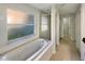 Bathroom features a garden tub under a large window and a glass-enclosed shower at 13108 Long Pine Trl, Clermont, FL 34711