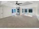 Spacious bedroom featuring a tray ceiling, ceiling fan and ample natural light from multiple windows at 13108 Long Pine Trl, Clermont, FL 34711