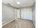 Sunlit bedroom featuring gray carpet, a closet, and a doorway to another room at 13108 Long Pine Trl, Clermont, FL 34711