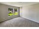 Cozy bedroom with plush carpeting and large windows offering views of the well-maintained front yard at 13108 Long Pine Trl, Clermont, FL 34711