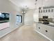Bright dining area with neutral tile flooring, large windows and easy access to the kitchen and backyard at 13108 Long Pine Trl, Clermont, FL 34711