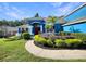Beautiful blue home with a well-manicured lawn and colorful landscaping at 13108 Long Pine Trl, Clermont, FL 34711