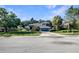 Bright blue two-story home with a well-maintained front yard and mature trees at 13108 Long Pine Trl, Clermont, FL 34711