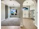 Inviting foyer features tile flooring leading into a bright living space with views of lush landscaping at 13108 Long Pine Trl, Clermont, FL 34711