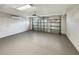 Spacious garage with gray epoxy flooring and insulated garage door, offering a clean and modern look at 13108 Long Pine Trl, Clermont, FL 34711