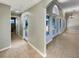 Open hallway with tile flooring, skylights, and multiple doorways leading to rooms with natural light at 13108 Long Pine Trl, Clermont, FL 34711