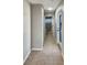 Tile hallway with skylight and doorways to a bathroom and outdoor access at 13108 Long Pine Trl, Clermont, FL 34711