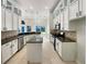 Modern kitchen with white cabinetry, an island, and stainless steel appliances at 13108 Long Pine Trl, Clermont, FL 34711