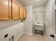 Convenient laundry room with overhead cabinets, utility sink, and ample space for laundry appliances at 13108 Long Pine Trl, Clermont, FL 34711