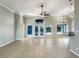 Spacious living room featuring tile floors, ceiling fan, and lots of natural light from the glass windows and doors at 13108 Long Pine Trl, Clermont, FL 34711