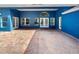 Large brick patio with covered area featuring multiple windows and glass doors at 13108 Long Pine Trl, Clermont, FL 34711