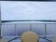 Breathtaking water views from this cozy balcony featuring a woven table and chairs at 13427 Blue Heron Dr # 2-1401, Orlando, FL 32821