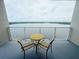 Balcony features a table with seating and a fantastic lake view at 13427 Blue Heron Dr # 2-1401, Orlando, FL 32821