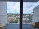 Balcony with seating overlooking a cityscape and trees at 13427 Blue Heron Dr # 2-1401, Orlando, FL 32821