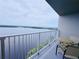 Scenic views of the waterfront can be enjoyed from this spacious balcony seating area at 13427 Blue Heron Dr # 2-1401, Orlando, FL 32821