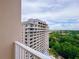 Balcony view of the high-rise architecture with a tranquil view of nature and the city skyline at 13427 Blue Heron Dr # 2-1401, Orlando, FL 32821