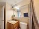 Bathroom with framed mirror, plant, granite countertop, vanity, and toilet at 13427 Blue Heron Dr # 2-1401, Orlando, FL 32821